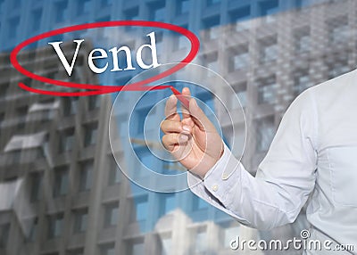 Hand of young businessman write the word Vend on skyscrapers background. Stock Photo