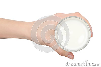 Hand of young girl holding glass of milk. Stock Photo