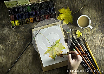 The hand young girl which draws sketch autumn leaf. Stock Photo