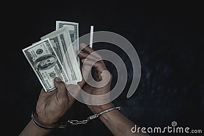 Hand young man in handcuffed hold money, Police arrest drug trafficker with handcuffs. Law and police concept Stock Photo