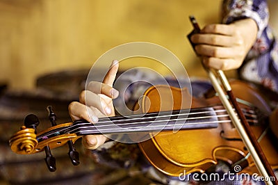 Hand of a young violinist holding the neck and pressing the strings playing violins, flat-lay Stock Photo