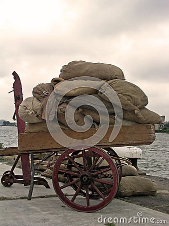 Handcart full of bags in Amsterdam harbor Stock Photo