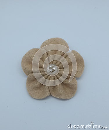 handcrafted brown flannel in the shape of a flower on a white background Stock Photo