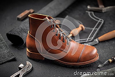 Handcrafted brown leather shoe with cobbler tools Stock Photo
