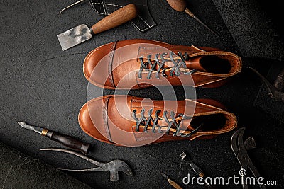 Handcrafted brown leather shoes with cobbler tools Stock Photo