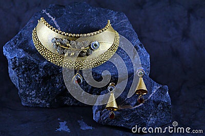 Handcrafted gold necklace with blue gems Stock Photo