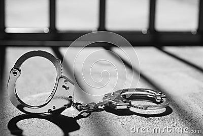 Handcuff and prison bars Stock Photo