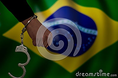 Handcuffed hand in front of the country flag. crime concept Stock Photo