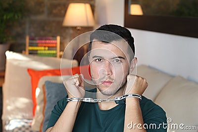 Handcuffed young man in the sofa Stock Photo