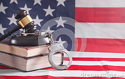 Handcuffs, book, judge gavel on the usa flag background Stock Photo