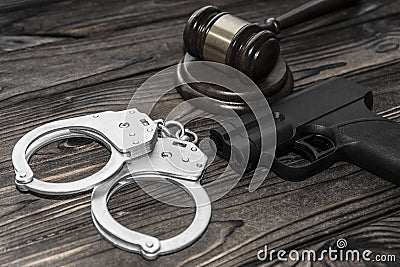 Handcuffs for detaining criminals, a judge`s hammer, Stock Photo