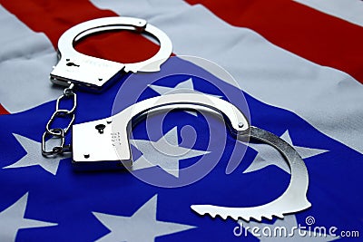 handcuffs on the flag of America, the concept of combating crime, corruption in the USA Stock Photo