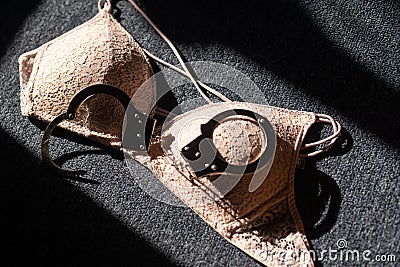 Handcuffs for sex games and bra. Sexual bdsm toy. Fetish, erotic concept. Stock Photo