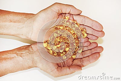 Handful of capsules omega-3 in palm of hand, close-up. Stock Photo