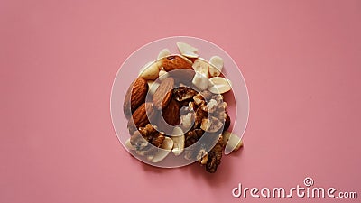 A handful of nuts on bright pink background, color background Stock Photo