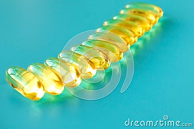 handful of omega 3 capsules on a blue background . Stock Photo