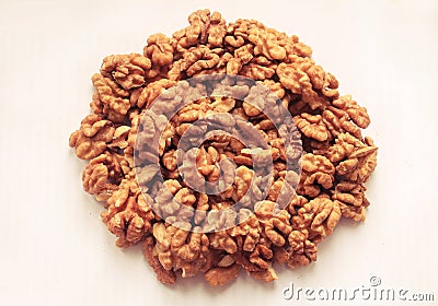 A handful of shelled walnuts on a white background. Stock Photo