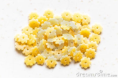 Handful uncooked stelle pasta pieces on gray Stock Photo