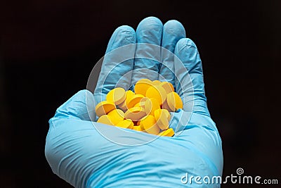 Handful of yellow round pills Stock Photo