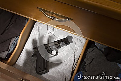 Handgun in dresser drawer Stock Photo