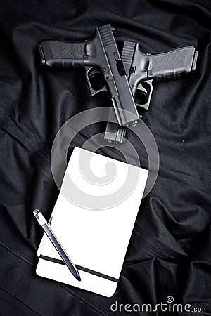 Handgun and notebook Stock Photo