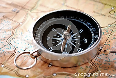 Handheld compass on a map Stock Photo