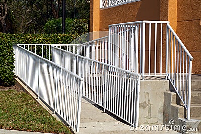 Handicap ramp with white railing Stock Photo