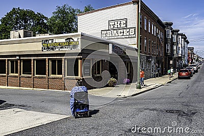 Handicap woman in motorized wheelchair crossing street Editorial Stock Photo