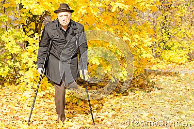 Handicapped elderly male amputee in a fall park Stock Photo