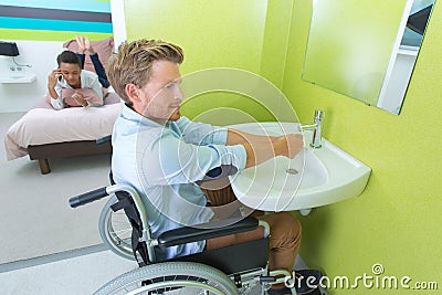 Handicapped man using hotel facilities Stock Photo