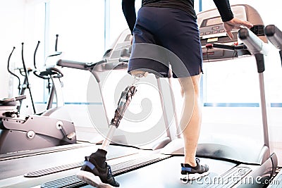 Handicapped Muscular Man Running on Treadmill Stock Photo