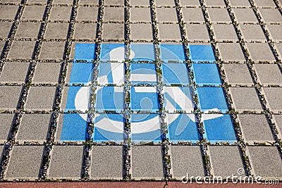 Handicapped parking spot - transportation infrastructure road markings and sign. Stock Photo