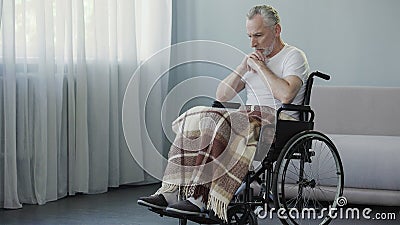 Handicapped person sitting in wheelchair and thinking about life, depression Stock Photo