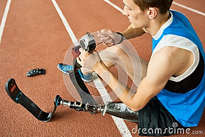 Handicapped Sportsman Repairing Prosthetic Leg Stock Photo