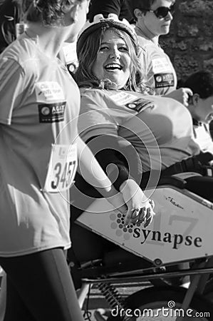 Handicapped woman is smiling at her friend during Les 10iemes FoulÃ©es marathon in Angouleme, France, in April 2016 Editorial Stock Photo