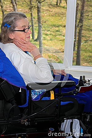 Handicapped woman by window Stock Photo