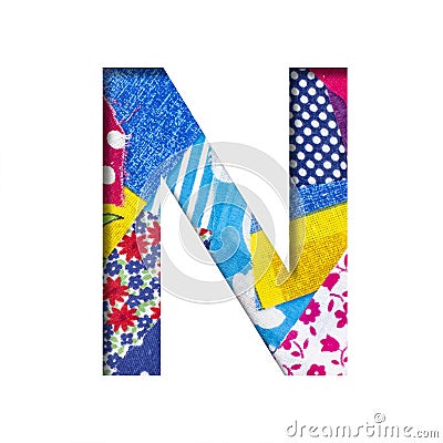 Handicraft or creative font. The letter N cut out of paper on the background of the texture of pieces of colored fabrics for home Stock Photo