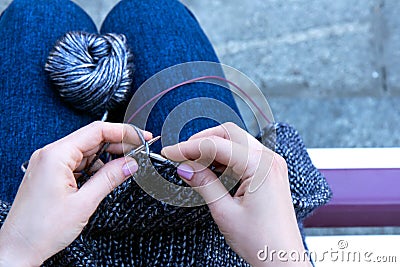 Handicraft earnings concept. Women`s rest and relaxation. Knitting outside the house Stock Photo