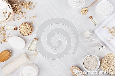 Handicraft natural cosmetics - white cream, oil, towel and bath accessories on soft light white wood table, frame, flat lay. Stock Photo