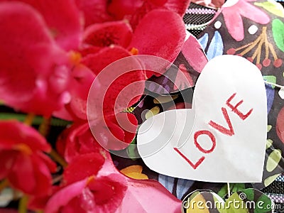 handicraft with the word love and red flowers on the side Stock Photo