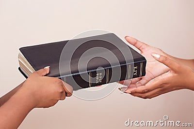 Girl Giving A Bible And Spreading The Good News Stock Photo