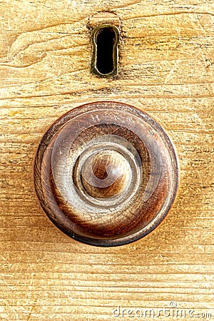 Handle on a drawer with keyhole escutcheon above. Stock Photo