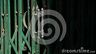 Handle of green vintage metal slide door and the shadow. Stock Photo