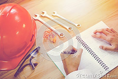 Handle pen to work Hat mechanic orange glasses and wrench Stock Photo