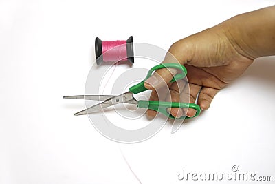 Handle scissors cuting pink Sewing thread Stock Photo