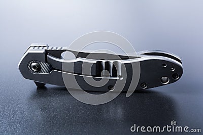 Handle Of A Standing Faint Military Knife On Dark Ground With Reflection Stock Photo