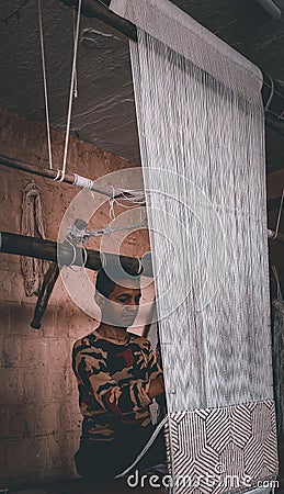 Handloom worker stitching a carpet for customers Editorial Stock Photo