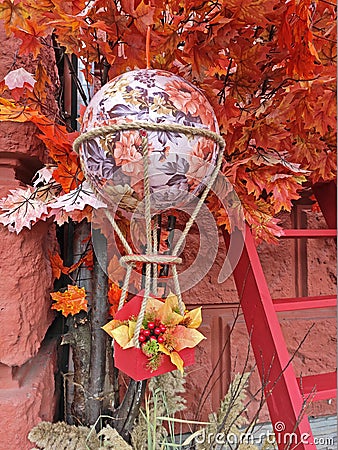 Aerostat hanging on an artificial autumn tree with a ladder Editorial Stock Photo