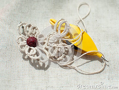 Handmade beige lace earrings, frivolite ankars technique. Stock Photo