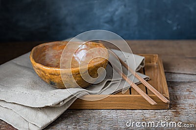 Handmade ceramic bowl on a wooden background, wabi sabi style Stock Photo